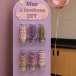 Un mur de bonbons coloré, parfait pour une fête d'enfants, rempli de friandises variées.